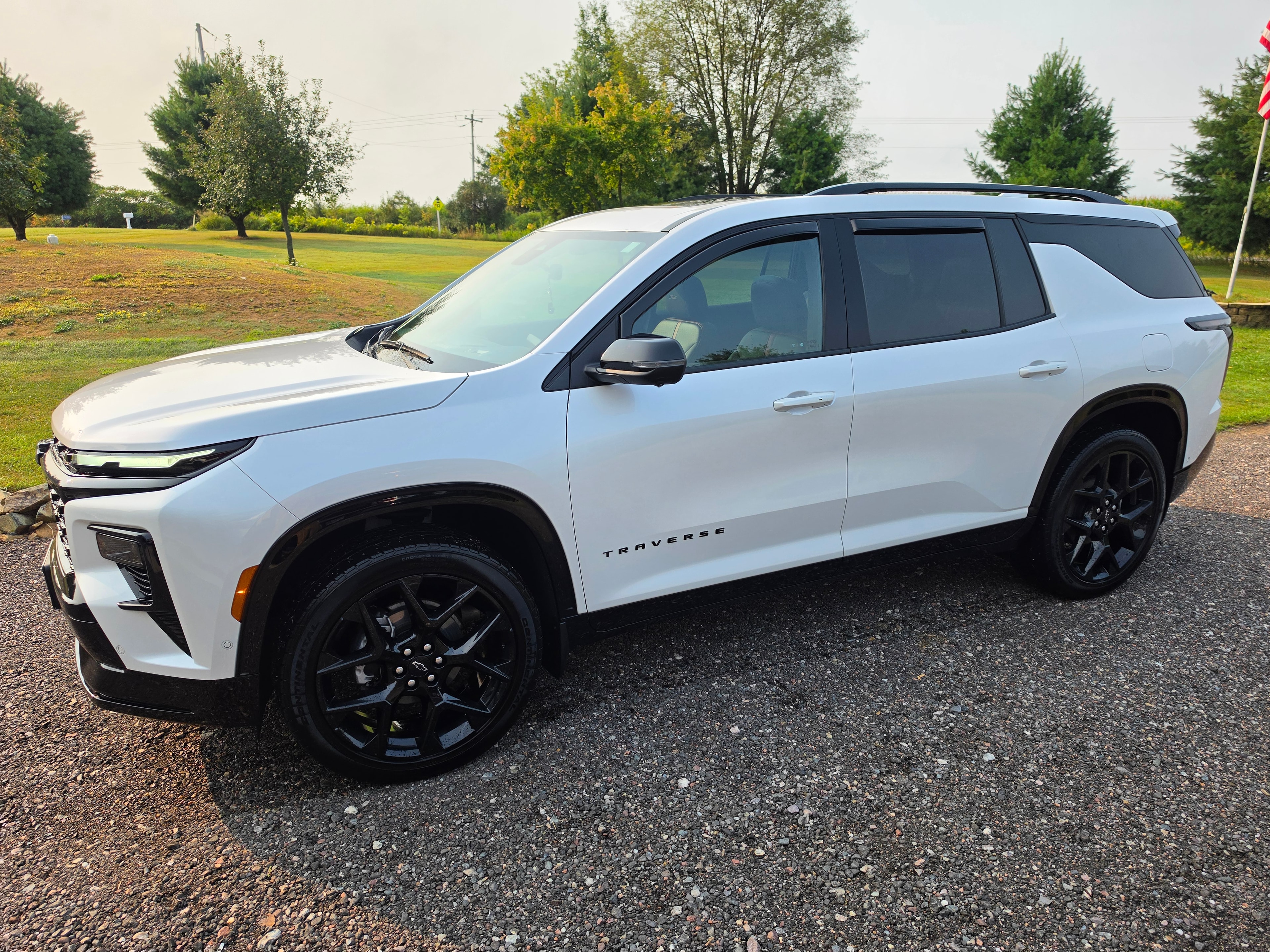 Partial vinyl wrap on white Chevrolet Traverse front view — VR Restoration Marathon WI